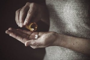 drugabuse shutterstock 251002813 man pouring excess pills into hand addict