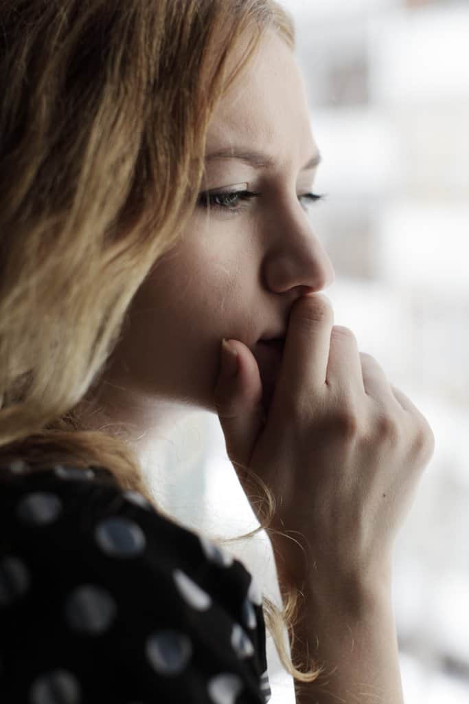 bigstock Sad woman loking at a window 18349031