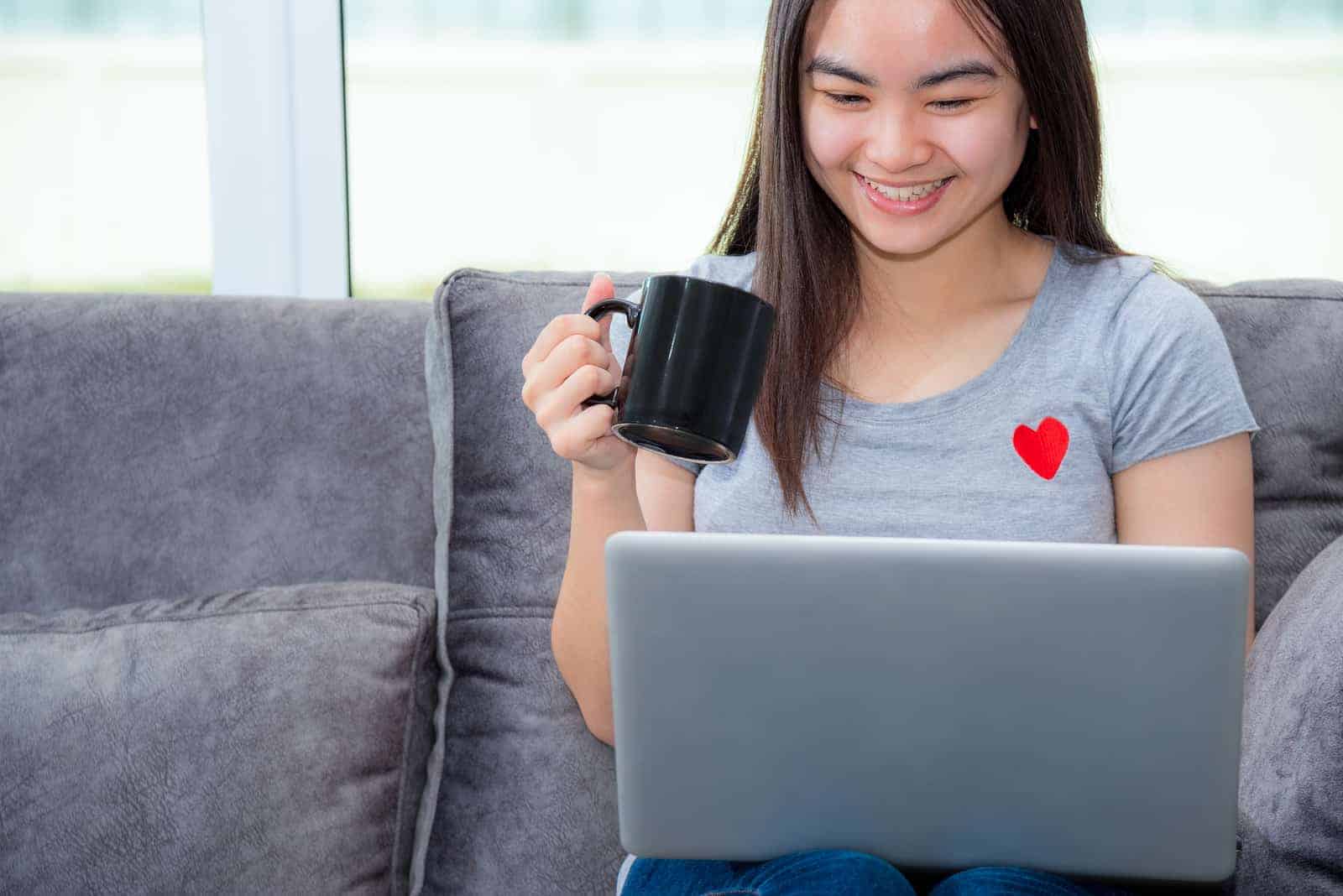 bigstock Asian Woman Holding A Coffee C 360877978